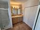 Bathroom featuring dual sinks, a shower stall, and large mirror with built-in lighting at 4923 5Th Street W Ct, Bradenton, FL 34207