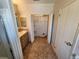 Practical bathroom with tiled floor, vanity, closet, and a door leading to additional space or storage at 4923 5Th Street W Ct, Bradenton, FL 34207