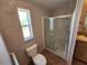 Bathroom showcasing a clean toilet, window, glass shower, and vanity sink at 4923 5Th Street W Ct, Bradenton, FL 34207