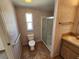 Bathroom featuring a shower, toilet, vanity, and grab bar for convenience and safety at 4923 5Th Street W Ct, Bradenton, FL 34207