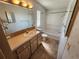 Well-lit bathroom with large mirror, vanity, and shower-tub combo at 4923 5Th Street W Ct, Bradenton, FL 34207