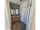 Bright bathroom featuring a double sink vanity, large mirror, walk-in shower, and closet at 4923 5Th Street W Ct, Bradenton, FL 34207