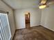 Comfortable bedroom featuring neutral walls, a ceiling fan, and doorway to the bathroom at 4923 5Th Street W Ct, Bradenton, FL 34207