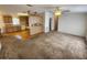 Open layout featuring kitchen with breakfast bar flowing into the carpeted living room at 4923 5Th Street W Ct, Bradenton, FL 34207