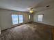Spacious living room featuring neutral paint, ceiling fan, and large windows letting in natural light at 4923 5Th Street W Ct, Bradenton, FL 34207