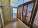 Enclosed patio with screened door and bamboo blinds at 4923 5Th Street W Ct, Bradenton, FL 34207