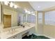 A well-lit bathroom features double sinks, a vanity area, and a separate shower for added convenience at 5308 88Th E St, Bradenton, FL 34211