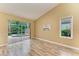 Bright bedroom with wood floors, sliding glass doors to patio, and vaulted ceiling, ideal for relaxation at 5308 88Th E St, Bradenton, FL 34211
