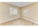Bedroom features plank flooring, neutral paint, and plantation shutters at 5308 88Th E St, Bradenton, FL 34211