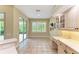 Bright breakfast nook with tiled floor, built-in cabinets, and sliding glass door to outdoor space at 5308 88Th E St, Bradenton, FL 34211