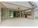 Spacious covered patio with an outdoor kitchen and ceiling fan, perfect for entertaining at 5308 88Th E St, Bradenton, FL 34211