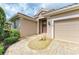 Close-up view of front entrance, showcasing double doors, manicured landscaping, and stone walkway at 5308 88Th E St, Bradenton, FL 34211