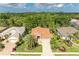 Charming home featuring a tile roof, lush landscaping, and a brick paved driveway, creating a welcoming curb appeal at 5308 88Th E St, Bradenton, FL 34211