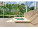 A screened-in patio with a built-in hot tub and lush landscaping offers a private and relaxing outdoor experience at 5308 88Th E St, Bradenton, FL 34211