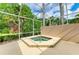 In-ground hot tub inside screened lanai offers a relaxing outdoor space with lush landscaping at 5308 88Th E St, Bradenton, FL 34211