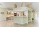 A kitchen with light wood cabinets, granite countertops, stainless appliances, and a breakfast bar at 5308 88Th E St, Bradenton, FL 34211