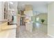 Kitchen with stainless steel appliances, light wood cabinets, and an adjacent open living space at 5308 88Th E St, Bradenton, FL 34211