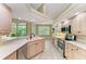 A well-lit kitchen featuring stainless appliances, a double sink, and views of the patio through a window at 5308 88Th E St, Bradenton, FL 34211