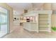 Light wood kitchen with stainless appliances, granite countertops, and access to the living room at 5308 88Th E St, Bradenton, FL 34211