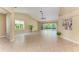 Spacious living room featuring tile flooring, high ceilings, and a wall of windows that bring the outside in at 5308 88Th E St, Bradenton, FL 34211