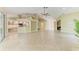 Expansive living space with tile floors, leading to a bar, kitchen, and other rooms at 5308 88Th E St, Bradenton, FL 34211