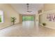 A bright and airy living room features neutral tones, tile floors, and access to the outdoors with a ceiling fan at 5308 88Th E St, Bradenton, FL 34211