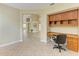 Neutral home office with custom built-ins adjacent to living area at 5308 88Th E St, Bradenton, FL 34211