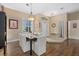 Dining room featuring white chairs, dark table, and natural light from a large window at 5510 Palm Aire Dr, Sarasota, FL 34243