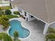 Aerial view of the home's backyard showcasing the pool, patio, landscaping, and the roof at 559 Spotted Slipper Pl, Ruskin, FL 33570
