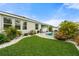 Lush backyard featuring a kidney-shaped pool, tropical landscaping, and a manicured lawn at 559 Spotted Slipper Pl, Ruskin, FL 33570