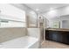 Modern bathroom featuring a separate tub and glass shower with a granite countertop at 559 Spotted Slipper Pl, Ruskin, FL 33570