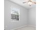 This bedroom features a large window that provides natural light and a ceiling fan at 559 Spotted Slipper Pl, Ruskin, FL 33570