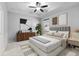 This bedroom features neutral paint, a ceiling fan, recessed lighting, and ample natural light from the window at 559 Spotted Slipper Pl, Ruskin, FL 33570