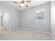 This bright bedroom features a window, carpet, and a ceiling fan at 559 Spotted Slipper Pl, Ruskin, FL 33570