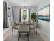 Elegant dining room with modern chandelier, stylish chairs, and natural lighting at 559 Spotted Slipper Pl, Ruskin, FL 33570