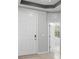 This home entryway has a light gray wall, a white door, and ceramic tile flooring at 559 Spotted Slipper Pl, Ruskin, FL 33570
