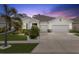 Charming single-story home featuring a three-car garage, lush landscaping, and a welcoming entrance at 559 Spotted Slipper Pl, Ruskin, FL 33570