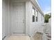 Exterior front door with light colored stucco and modern design at 559 Spotted Slipper Pl, Ruskin, FL 33570