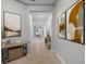 Bright hallway decorated with modern art leading to other rooms in the home at 559 Spotted Slipper Pl, Ruskin, FL 33570