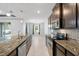 Spacious kitchen with granite countertops, stainless steel appliances, and open layout at 559 Spotted Slipper Pl, Ruskin, FL 33570