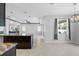Open-concept kitchen view with a large island and modern pendant lighting at 559 Spotted Slipper Pl, Ruskin, FL 33570