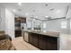 Open kitchen featuring granite countertops, stainless appliances, large island, and breakfast nook at 559 Spotted Slipper Pl, Ruskin, FL 33570