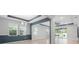 Spacious living room area with large windows overlooking the pool and patio at 559 Spotted Slipper Pl, Ruskin, FL 33570