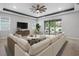 Inviting living room featuring a large sectional sofa and sliding glass doors to outdoor patio at 559 Spotted Slipper Pl, Ruskin, FL 33570