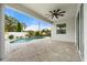 Covered patio features a ceiling fan, stone flooring, and a great view of the backyard pool at 559 Spotted Slipper Pl, Ruskin, FL 33570