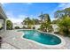 Backyard swimming pool surrounded by palm trees and a white fence, offering a private oasis at 559 Spotted Slipper Pl, Ruskin, FL 33570