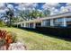 Spacious backyard with a well-maintained lawn, providing an ideal setting for outdoor activities and relaxation at 5621 Palm Aire Dr, Sarasota, FL 34243