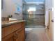 Stylishly updated bathroom featuring a tiled shower with glass door, updated vanity, and fixtures at 5621 Palm Aire Dr, Sarasota, FL 34243