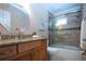 Well-appointed bathroom features a walk-in shower with glass door, a granite-topped vanity, and modern fixtures at 5621 Palm Aire Dr, Sarasota, FL 34243