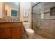 Bathroom featuring a vanity with stone countertops, a toilet and a glass-enclosed shower stall at 5621 Palm Aire Dr, Sarasota, FL 34243